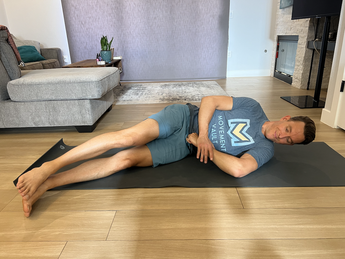 male physical therapist demonstrates one of the best rotator cuff stretches