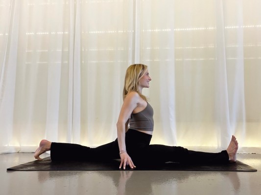 Yoga teacher demonstrating splits