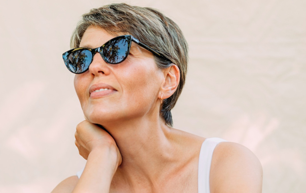 Portrait of a beautiful woman in her 50s captured outdoors for a story about stick sunscreen