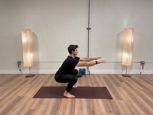 Personal trainer demonstrating air squat