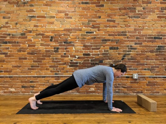 Pregnant person demonstrating high plank pose