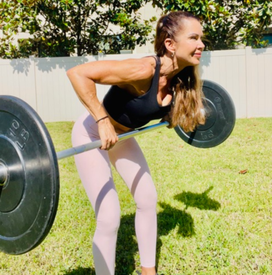 Personal trainer demonstrating bent-over barbell row