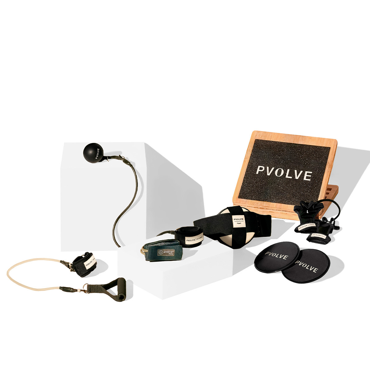 Exercise bands, balls, and gliders with the Pvolve logo.